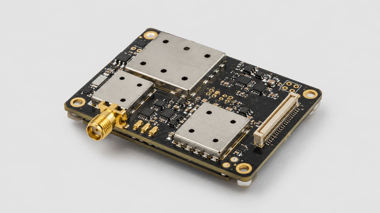Close up view of a compact RF module circuit board featuring micro-coaxial connectors, gold traces, and a metal shielding can.