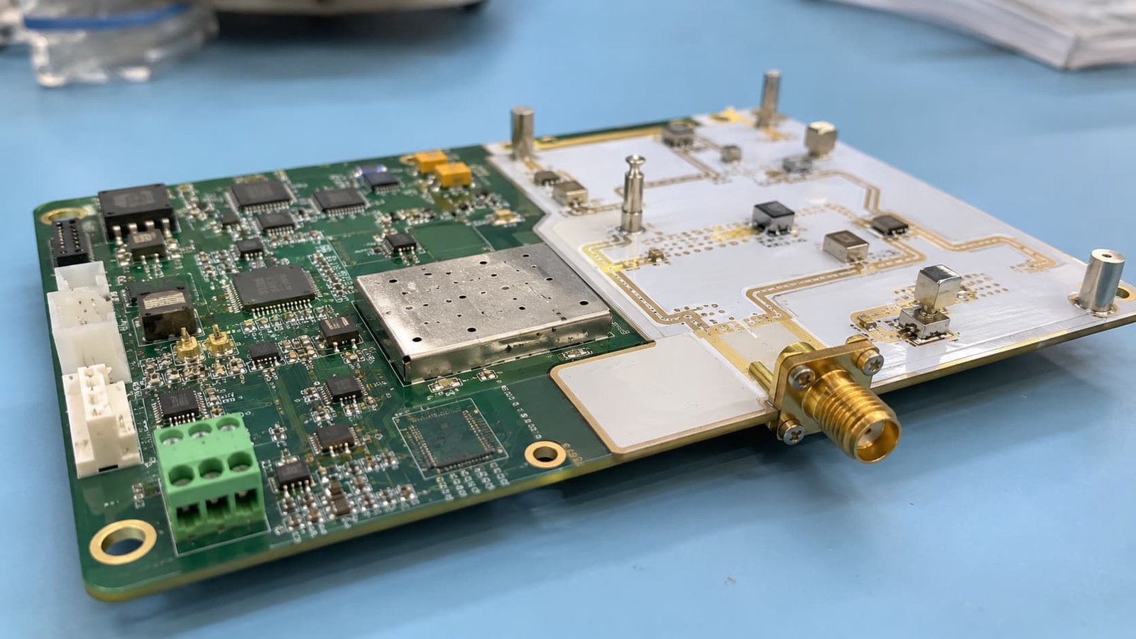 Side-by-side comparison of a standard FR4 circuit board and a high-frequency PTFE PCB, highlighting the difference in substrate material and RF traces.